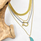 layered gold and silver chunky necklaces with green moon and carabiner 