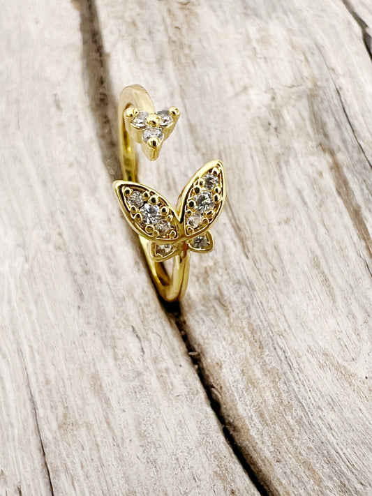 Gold-plated stainless steel rings with CZ-studded butterfly. Adjustable, waterproof, and hypoallergenic.