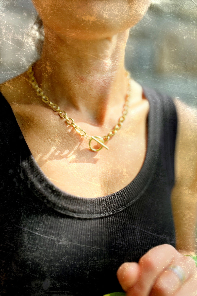 woman wearing a Chunky gold stainless steel necklace with a toggle clasp for a statement look