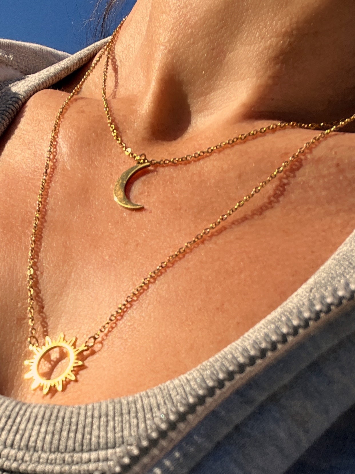 Double-layered 14k gold-plated stainless steel necklace with a sun and moon charm. Waterproof, tarnish-resistant, and perfect for layering.