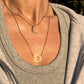 Double-layered 14k gold-plated stainless steel necklace with a sun and moon charm. Waterproof, tarnish-resistant, and perfect for layering.