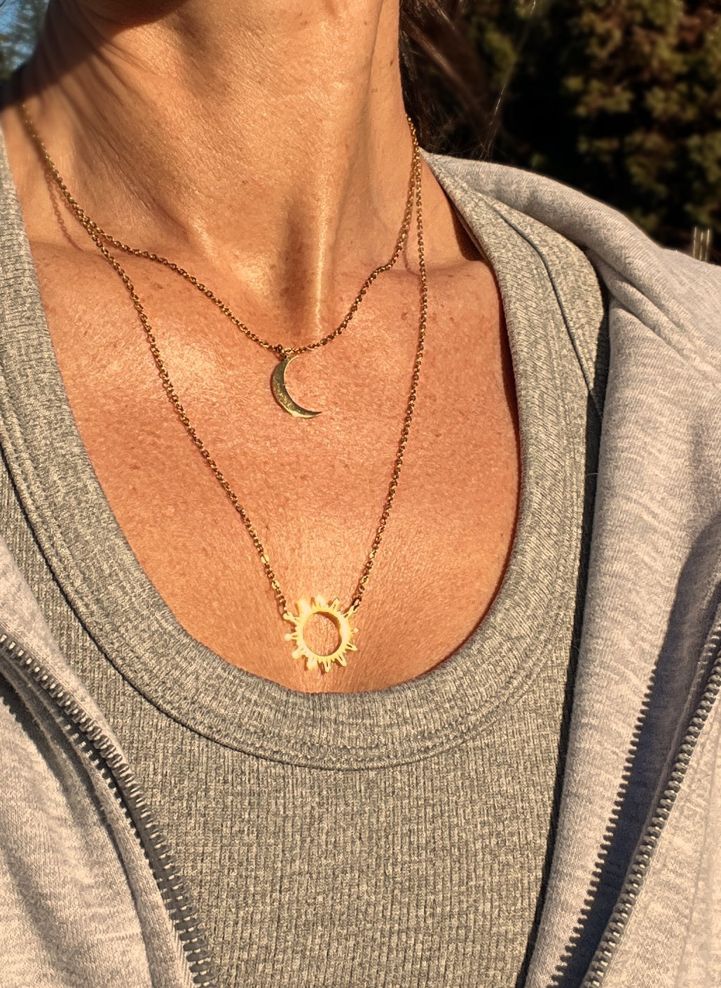 Double-layered 14k gold-plated stainless steel necklace with a sun and moon charm. Waterproof, tarnish-resistant, and perfect for layering.