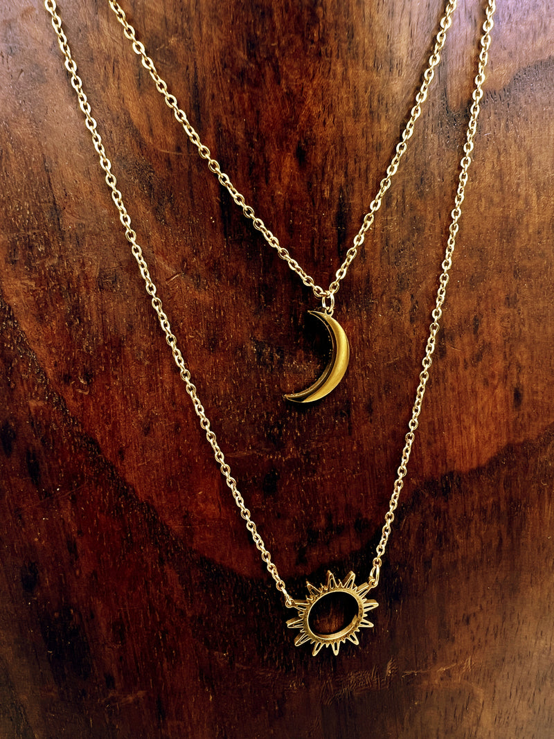 Double-layered 14k gold-plated stainless steel necklace with a sun and moon charm. Waterproof, tarnish-resistant, and perfect for layering.