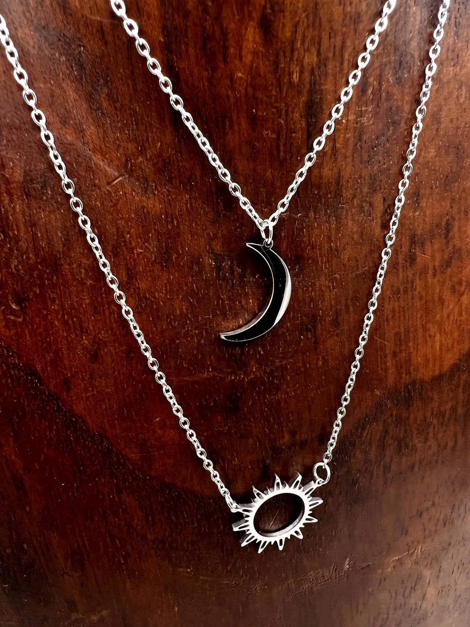 Double-layered 14k gold-plated stainless steel necklace with a sun and moon charm. Waterproof, tarnish-resistant, and perfect for layering.