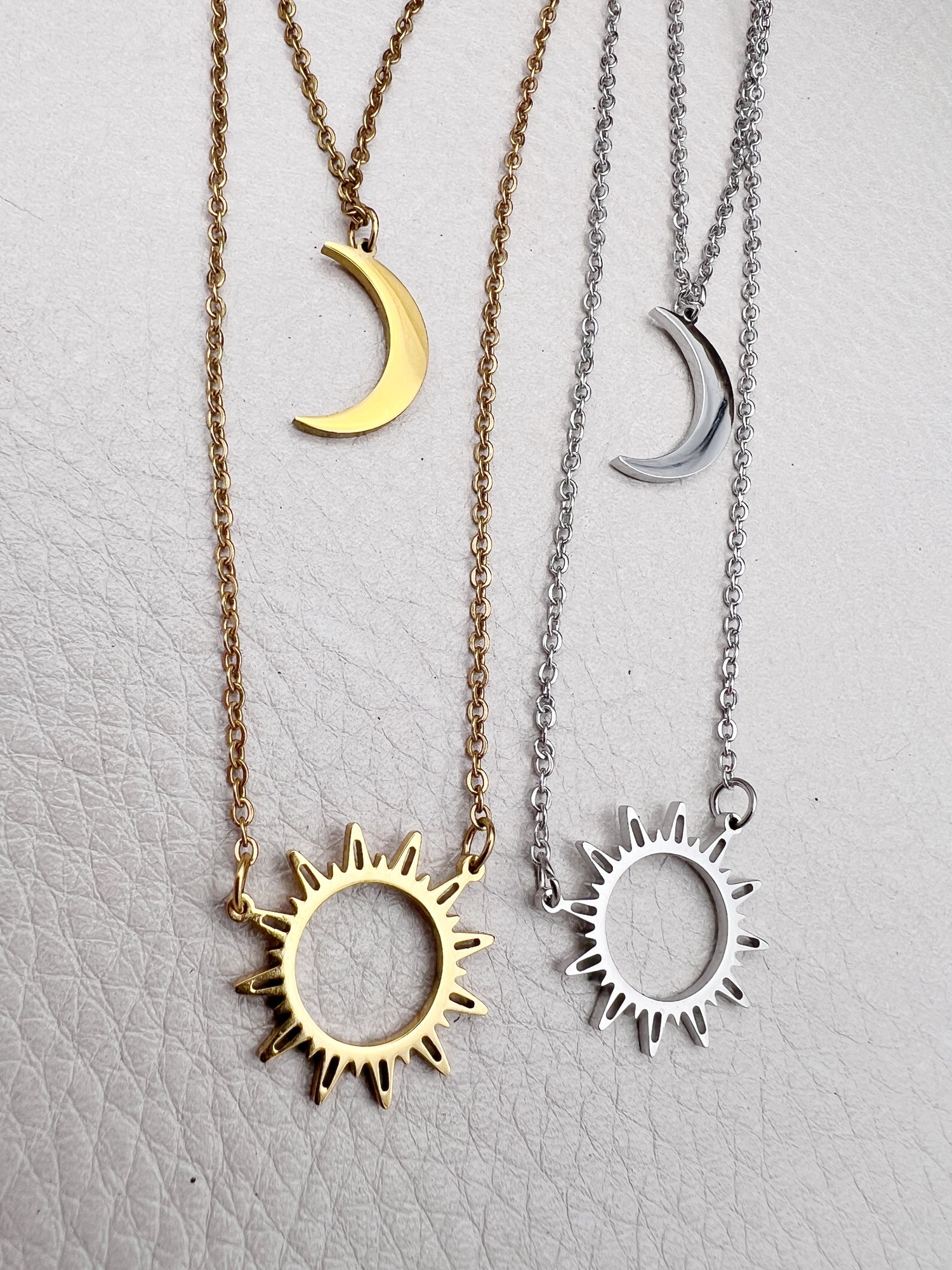 Double-layered 14k gold-plated stainless steel necklace with a sun and moon charm. Waterproof, tarnish-resistant, and perfect for layering.