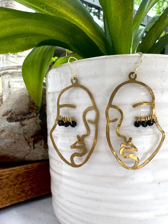 Hammered brass face earrings with wired black beaded lashes in customizable colors. 14k gold-filled ear wires, lightweight and full of personality