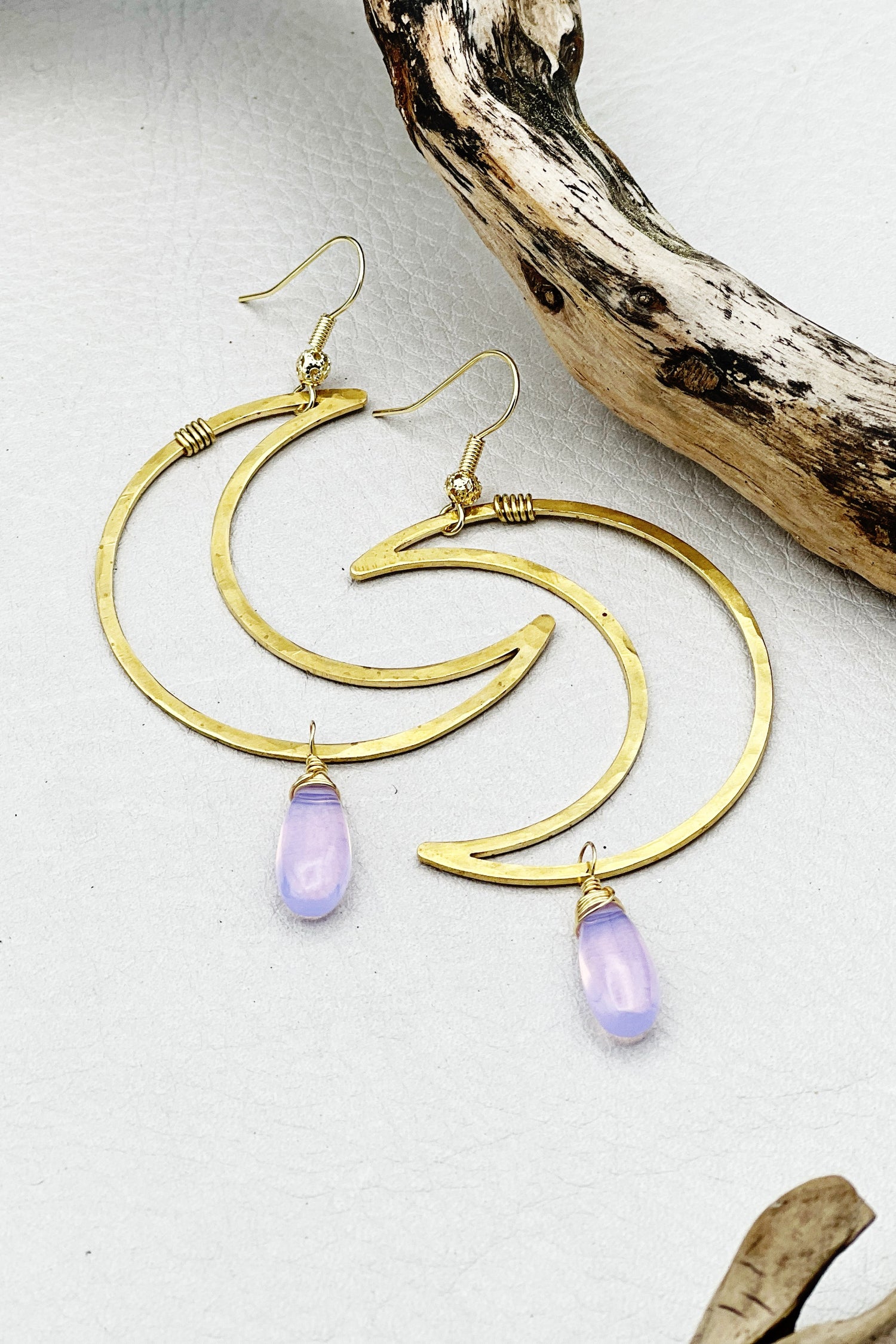 Hammered brass crescent moon earrings with lavender quartz teardrops. Handmade, wired, and lightweight for effortless boho style.