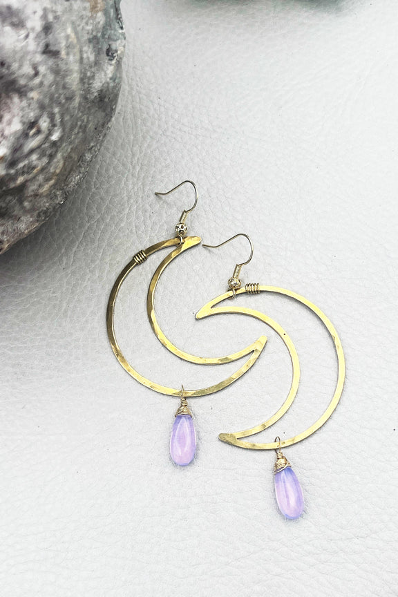 two hammered moon shaped earrings with a lavender colored droplet on the bottom