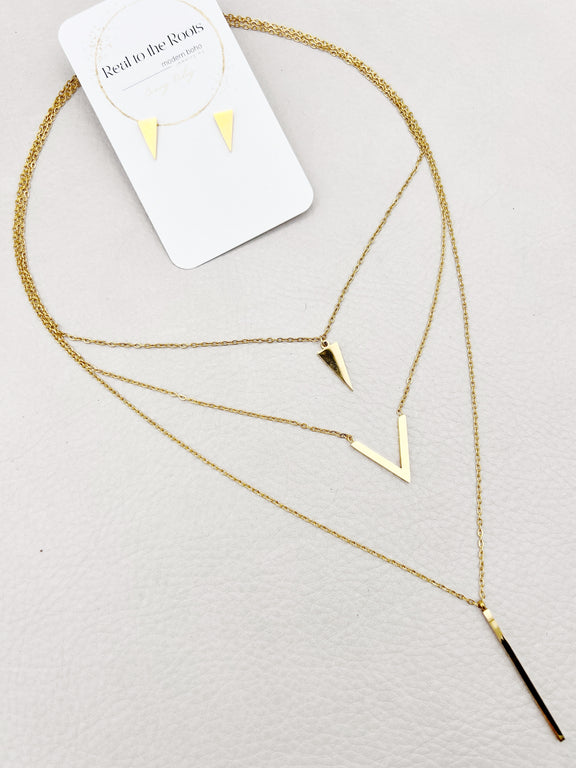 golden layered necklace with triangle, V shape and spike pendants