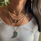 layered gold and silver chunky necklaces with green moon and carabiner 