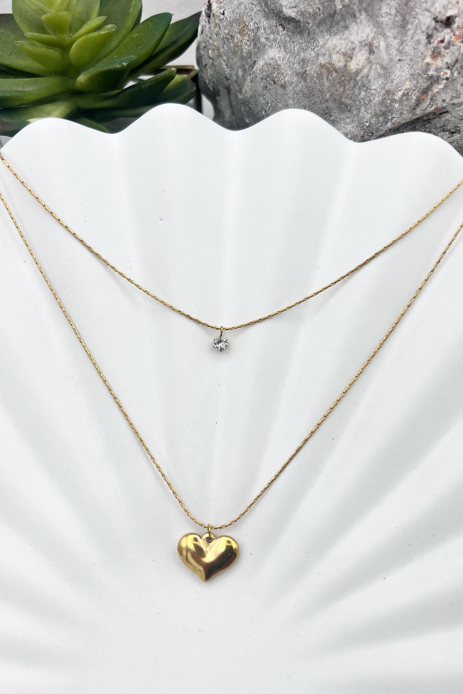 layered gold necklace with cubic zirconia and golden heart