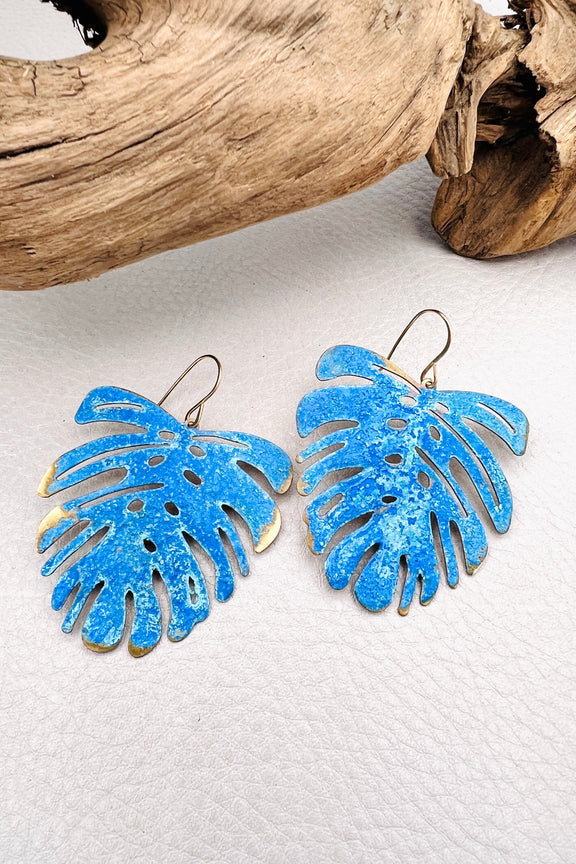 Vivacious modern boho statement jewelry – handcrafted blue patina monstera leaf earrings, a bold and artistic design from Real to the Roots Jewelry. 