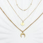 Triple-layered 14k gold-plated stainless steel necklace with a crescent moon, sun coin, and satellite chain. Waterproof and tarnish-resistant.