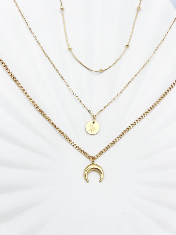 Triple-layered 14k gold-plated stainless steel necklace with a crescent moon, sun coin, and satellite chain. Waterproof and tarnish-resistant.