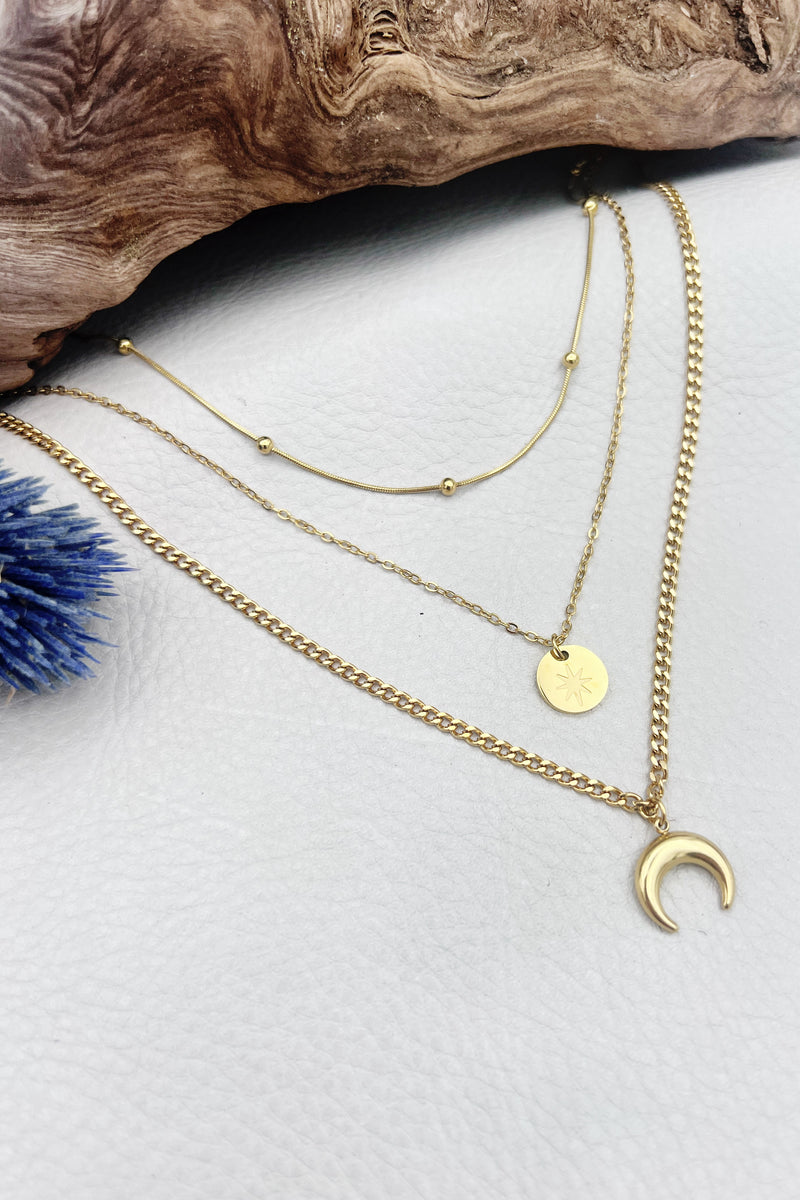 Triple-layered 14k gold-plated stainless steel necklace with a crescent moon, sun coin, and satellite chain. Waterproof and tarnish-resistant.